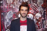 Enrique del Val in front of a painting by Carlos Barrios at our Paella Night 2011.